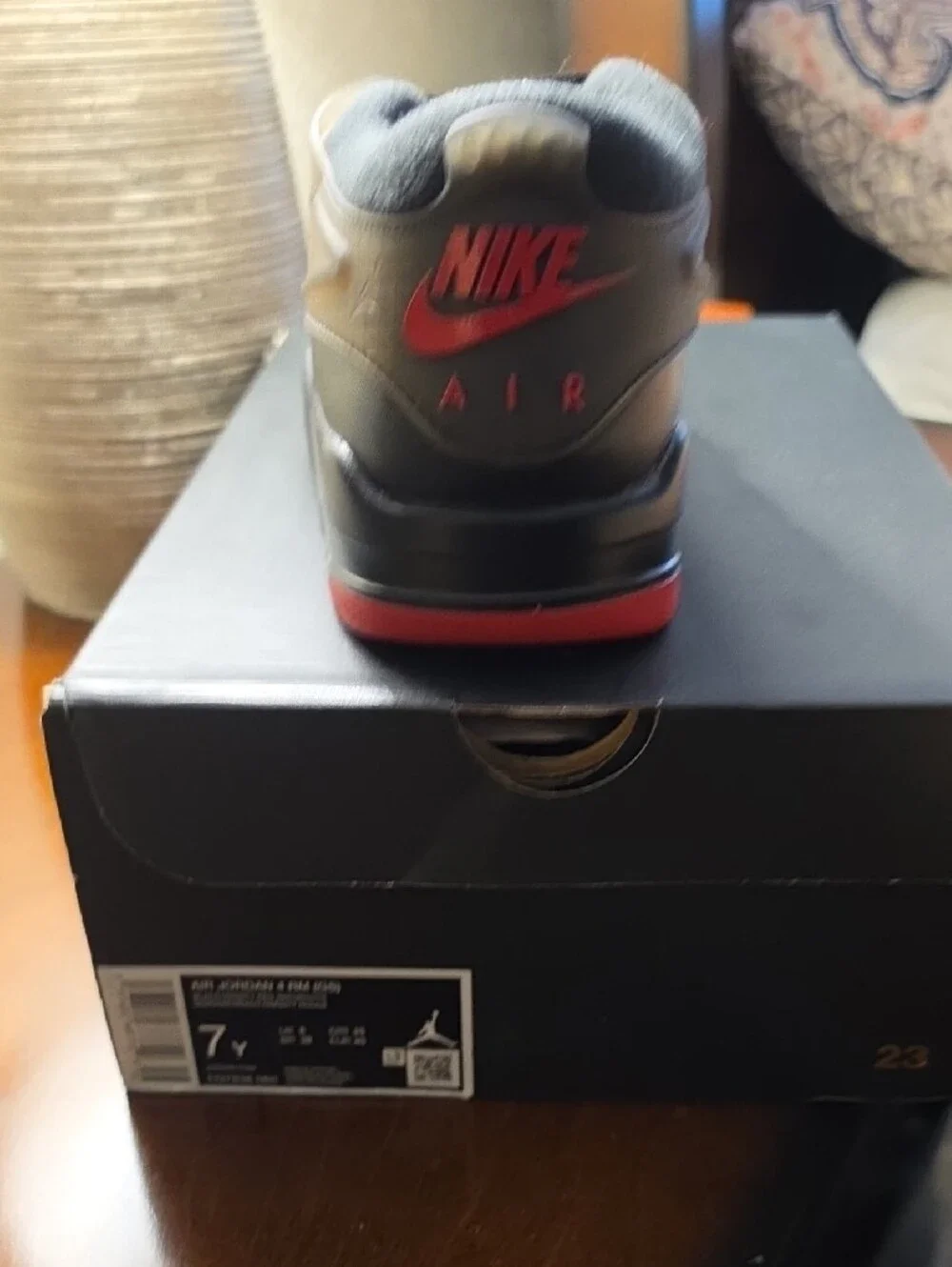 Air Jordan 4 RM Youth Athletic Shoe in Black with Red Accents 7Y